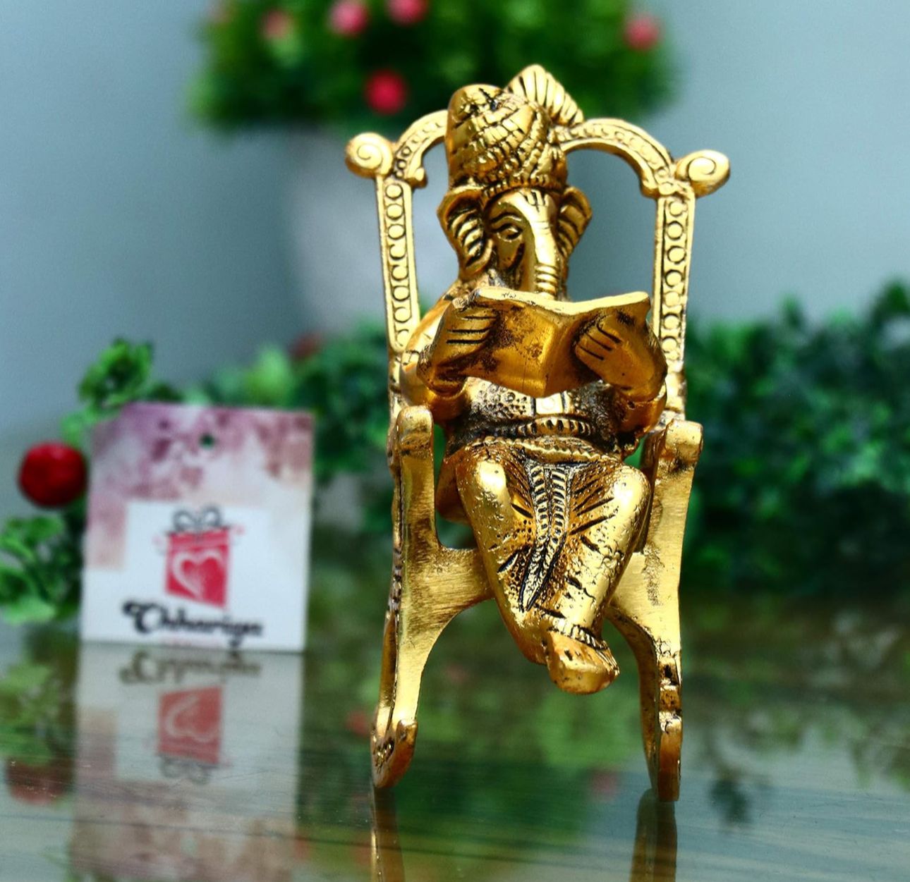 Metal Lord Ganesh Reading Ramayana Statue Ganpati Sitting on Chair with Kuber Diya in Berlin