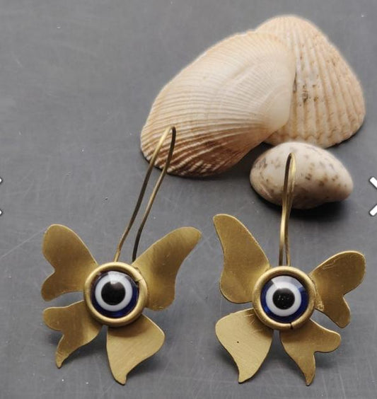 Evil eye stone with butterfly shaped brass earrings in Germany