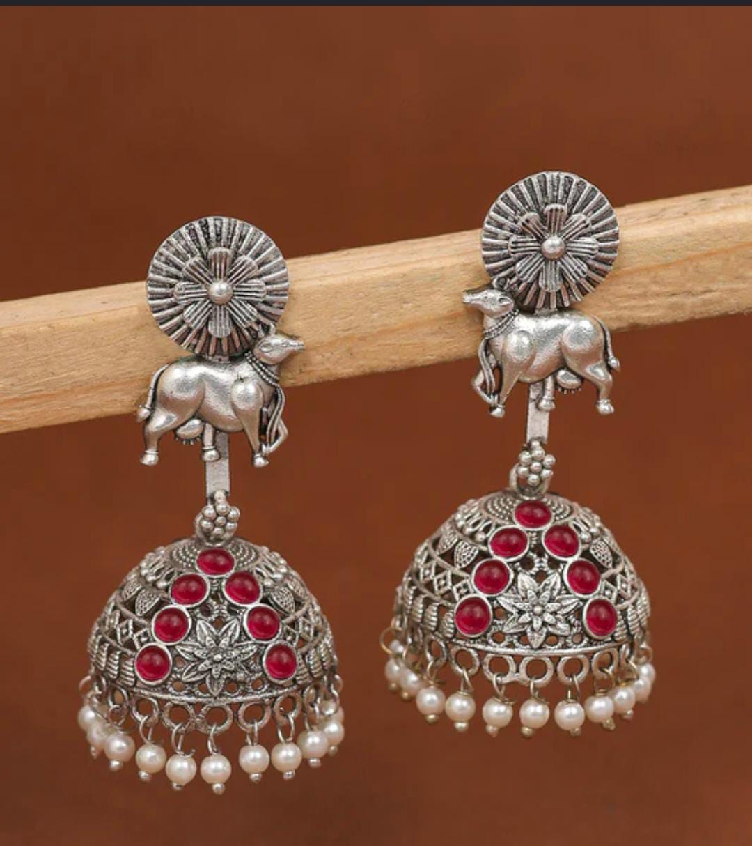 Oxidized Silver Kamdhenu Cow Motif Jhumka Earrings with Red Stones & Pearl Drops in Germany