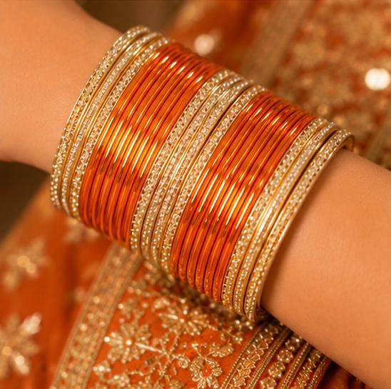 Orange and gold traditional bangle set in Germany