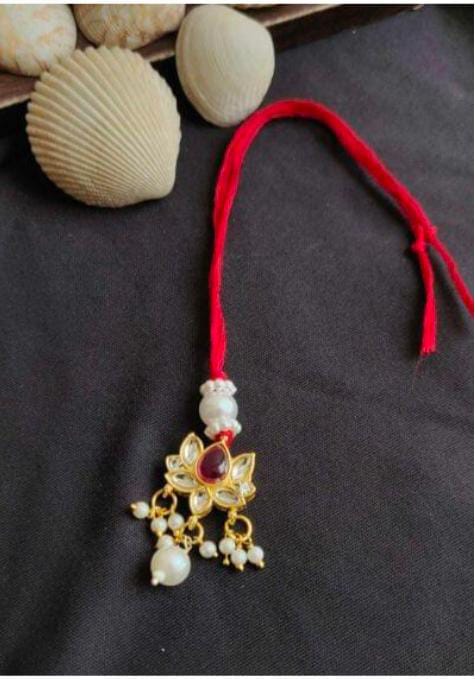 Handcrafted Lotus Kundan Rakhi with Pearl Accents and Red Thread in Germany