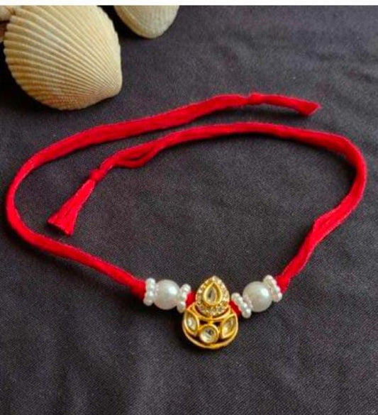 Elegant Teardrop Kundan Red Thread Rakhi with Pearl Embellishments in Germany